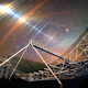 The CHIME radio telescope beneath the night sky, which covered in superimposed streaks of color.